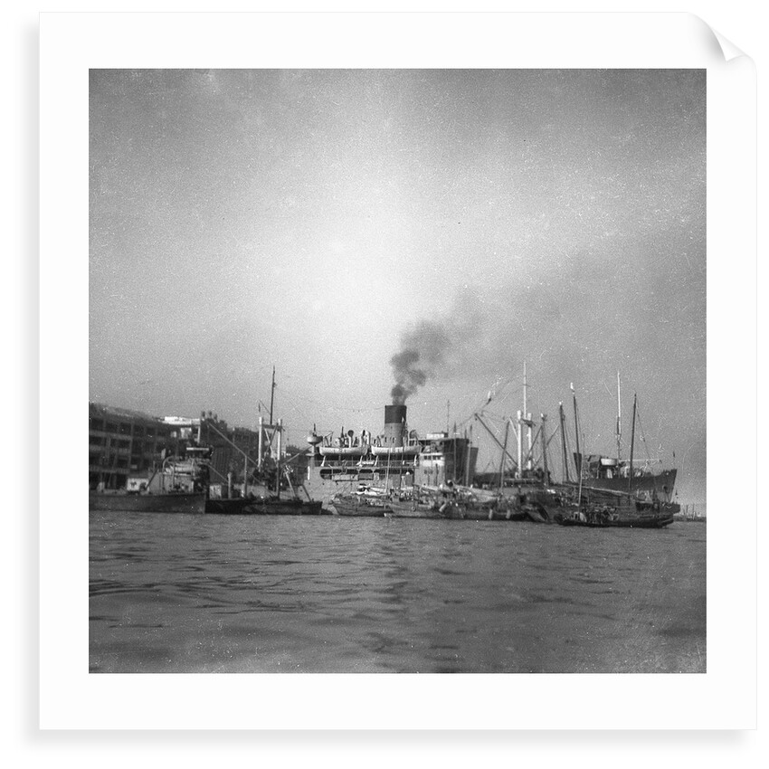 'Wing Sang' (Br, 1938), at anchor, surrounded by small craft by unknown