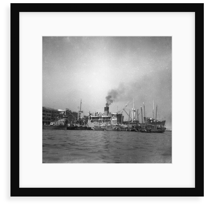 'Wing Sang' (Br, 1938), at anchor, surrounded by small craft by unknown