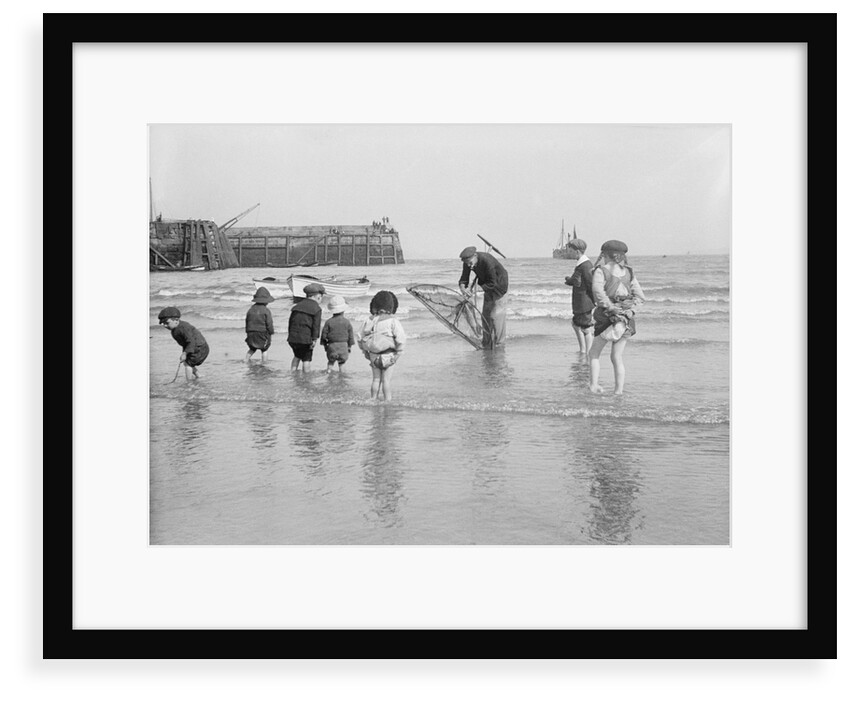 Boys and girls watch intently as a local fisherman wields his net in Scarborough, Yorkshire by Samuel Coupe Fox