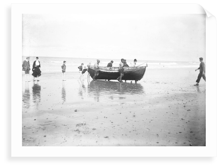 Five fishermen carrying a Sheringham crab boat up the beach, assisted by three boys, at Lowestoft by Smiths Suitall Ltd.