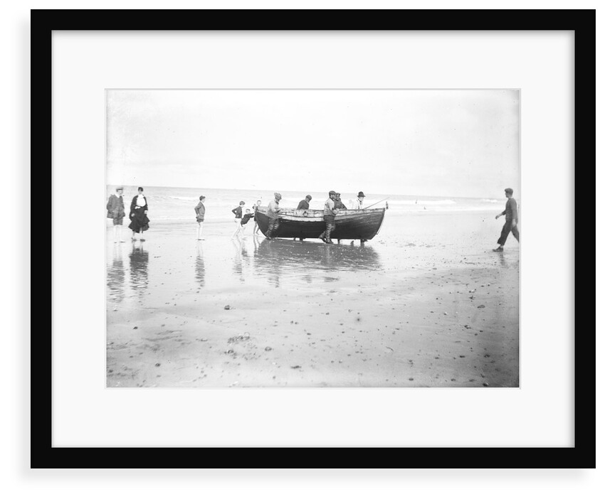 Five fishermen carrying a Sheringham crab boat up the beach, assisted by three boys, at Lowestoft by Smiths Suitall Ltd.