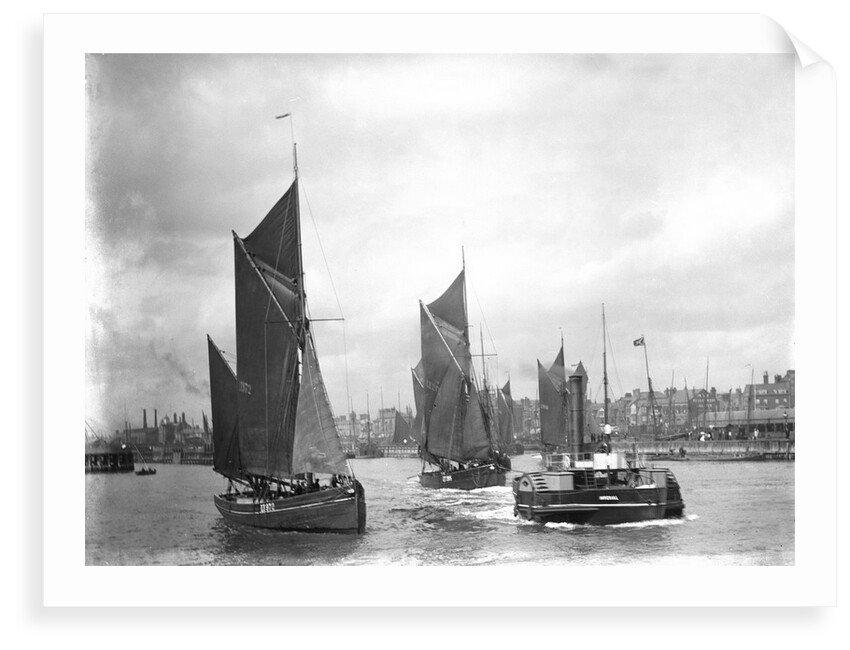 The trawler 'LT372' under sail with 'LT205' in tow of the paddle tug 'Imperial' (1879) leaving the harbour at Lowestoft, Suffolk by Smiths Suitall Ltd.