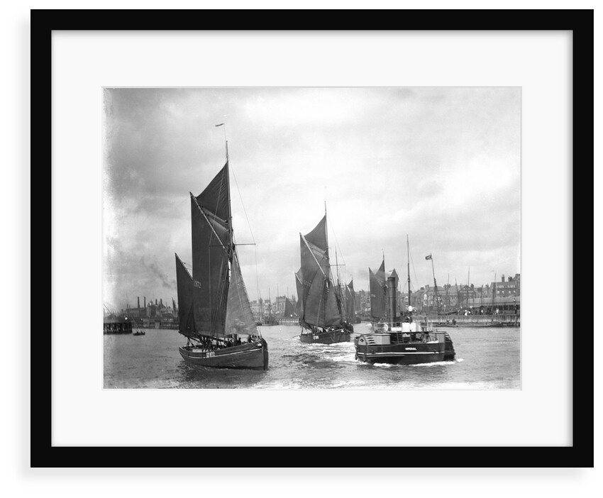 The trawler 'LT372' under sail with 'LT205' in tow of the paddle tug 'Imperial' (1879) leaving the harbour at Lowestoft, Suffolk by Smiths Suitall Ltd.