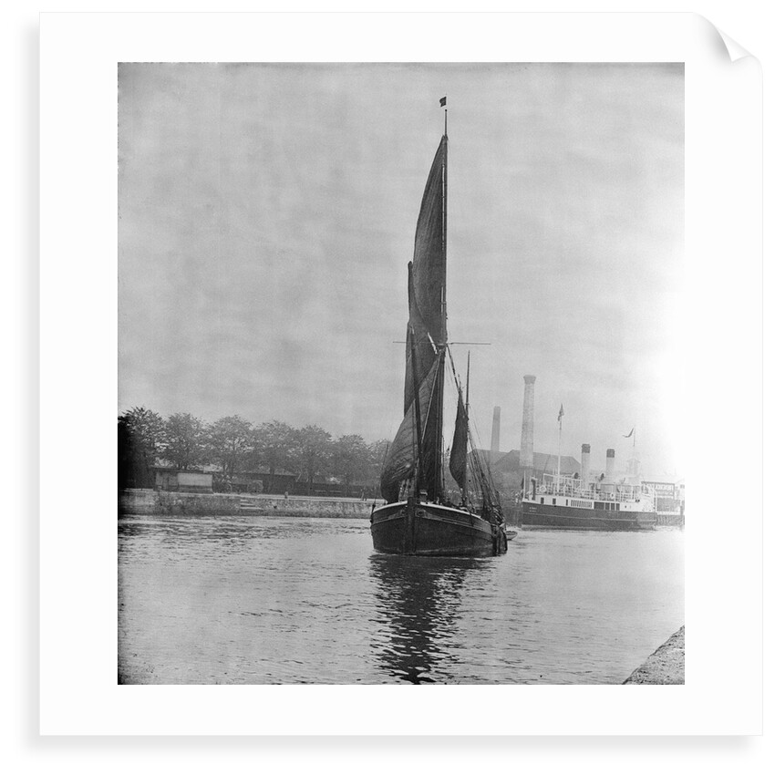 A view across the New Cut at Ipswich with an unidentified spritsail barge under sail leaving by Smiths Suitall Ltd.