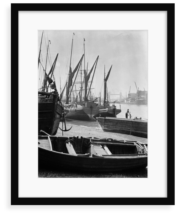 The Thames at low water with various crafts beached on the Southbank and Tower Bridge in the background. by Eagar