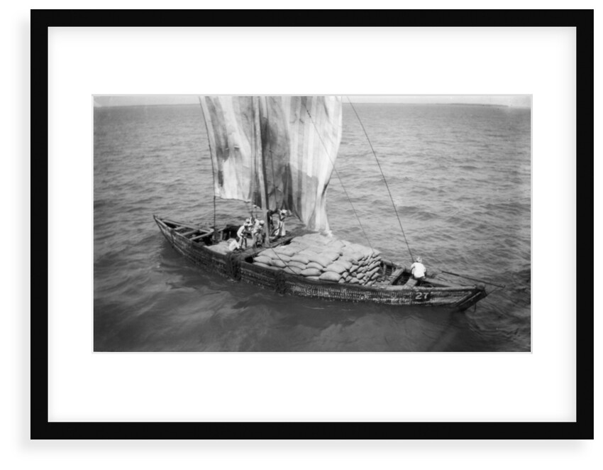Indigenous boat at sea, laden with sacks by unknown