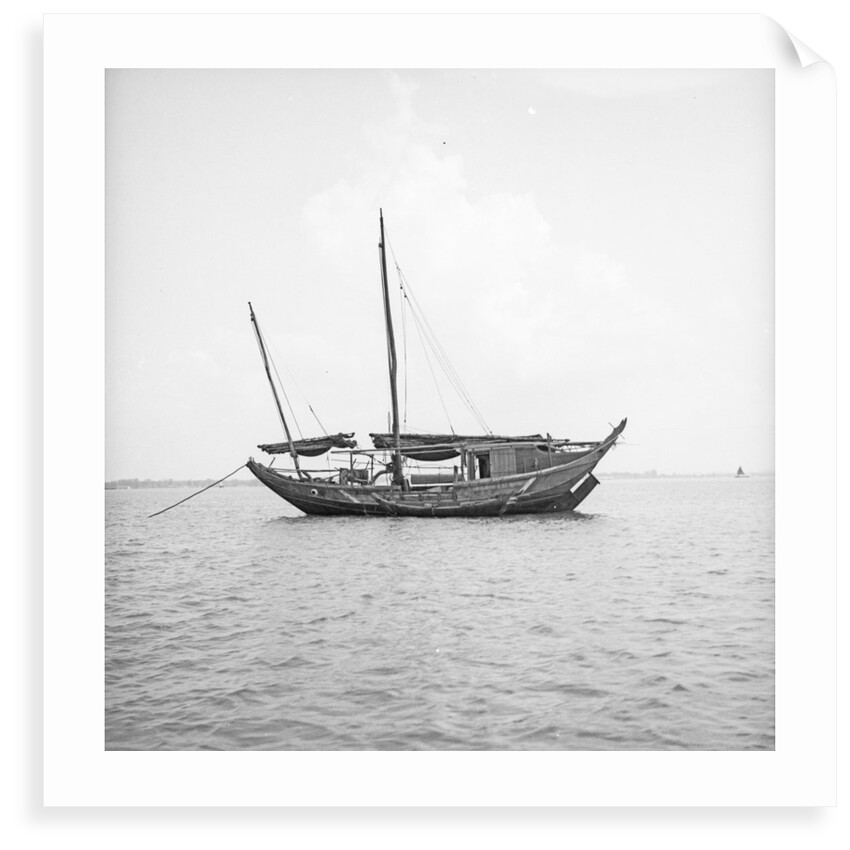 A port broadside view of a small fisher type junk anchored at Penang by David Watkin Waters