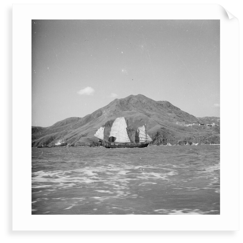 A distant starboard beam view of a Yeungkong fisher type junk under sail in Sai Wan Bay off Lyemun, Hong Kong by David Watkin Waters