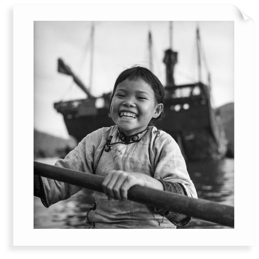 A portrait of a young girl in a sampan in Aberdeen harbour, Hong Kong. by David Watkin Waters