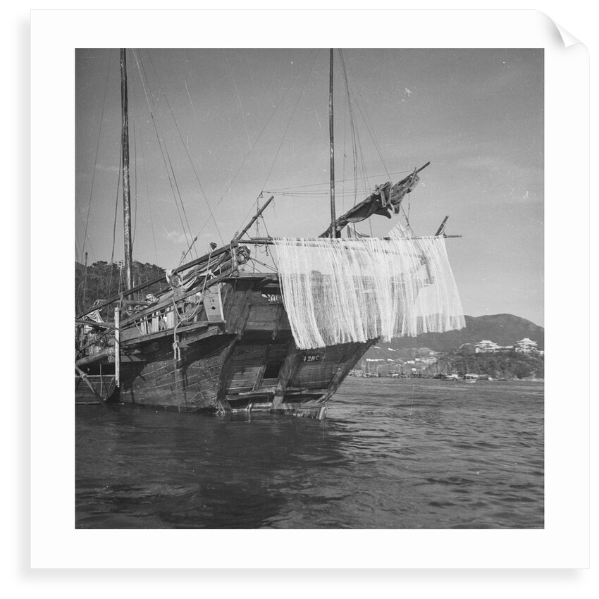 A port quarter view of an Aberdeen frame stern fisher type junk in Hong Kong harbour by David Watkin Waters