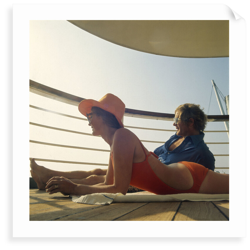 A couple relax and enjoy the sea view on board an unspecificed cruise liner by unknown