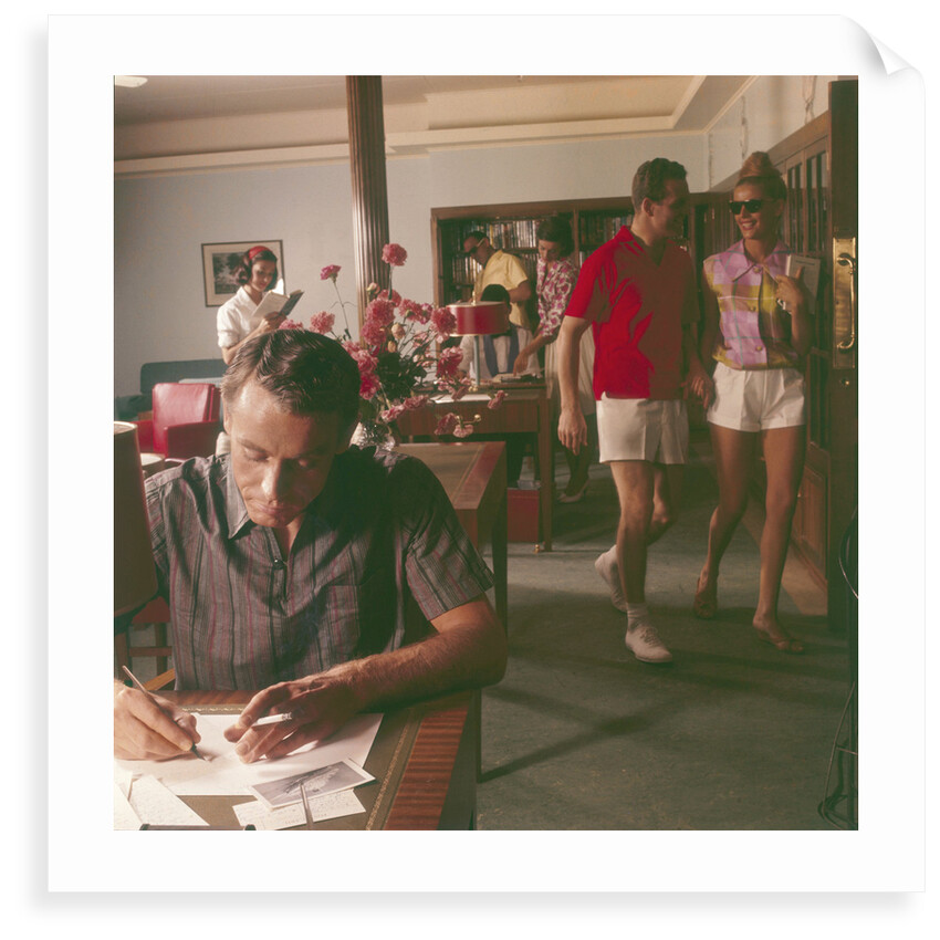 Passengers on board an unspecified cruiser liner pass the time by writing and walking the ship by Marine Photo Service