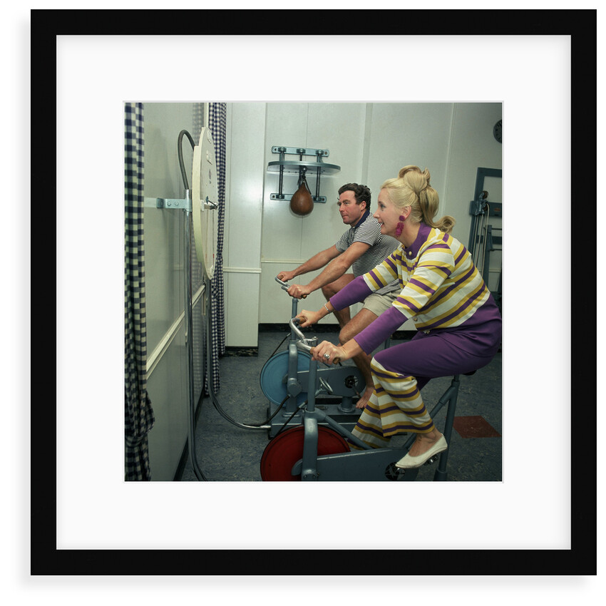 After all the lunches and cocktail evenings, a little exercise is just the thing: two passengers use exercise bikes in the gym of an unspecified cruise liner by Marine Photo Service
