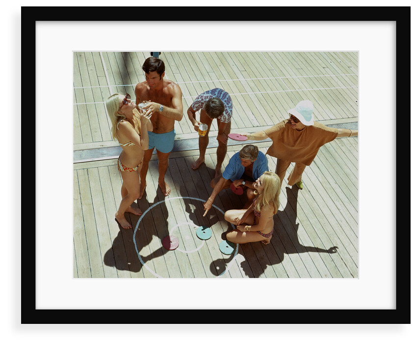 A group of passengers aboard an unspecified cruise ship enjoy a game of deck quoits by Union Castle Line Collection