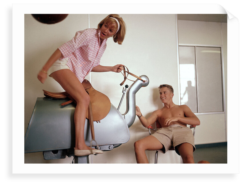 Exercise, hilarity and hijinks combined: a couple enjoy the novel pleasures of a 'bucking bronco' machine on board an unspecified cruise ship by Marine Photo Service