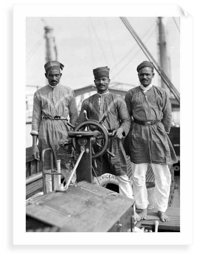 Three Lascars of the 'Viceroy of India' (1929), standing behind the wheel of one of the ship's tenders by Marine Photo Service