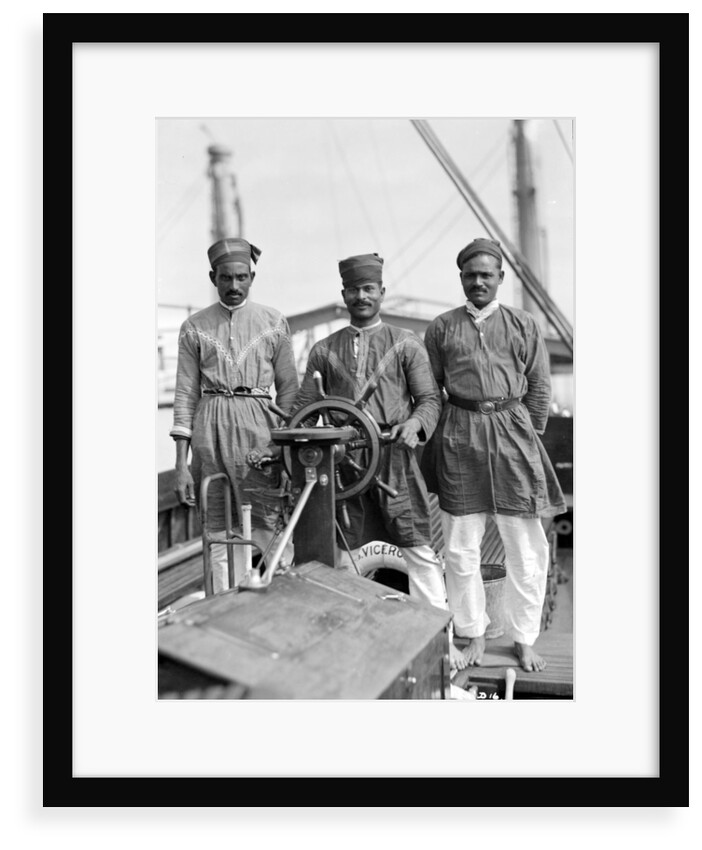 Three Lascars of the 'Viceroy of India' (1929), standing behind the wheel of one of the ship's tenders by Marine Photo Service