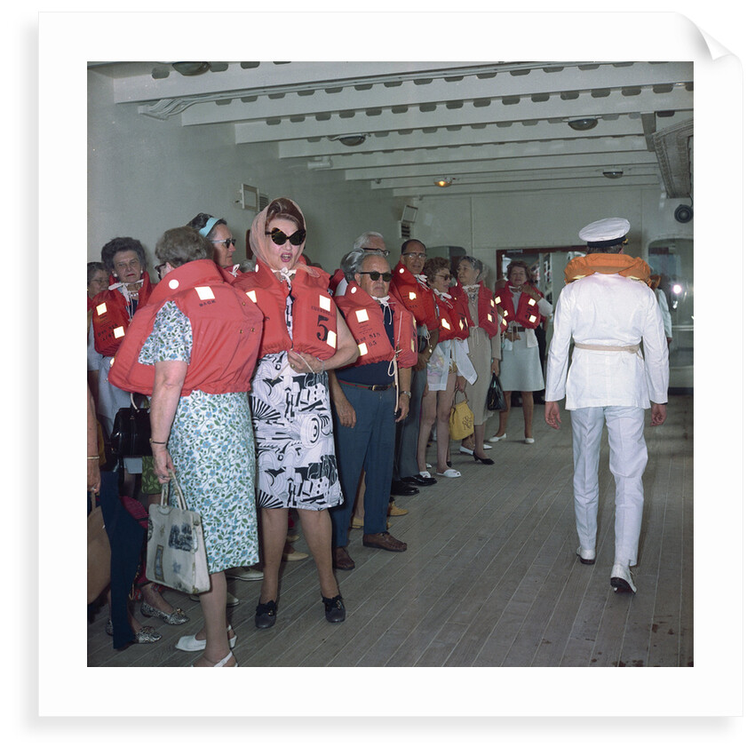 A group of passengers with lifejackets aboard 'Kungsholm' (1966), undergoing life boat drill by Marine Photo Service