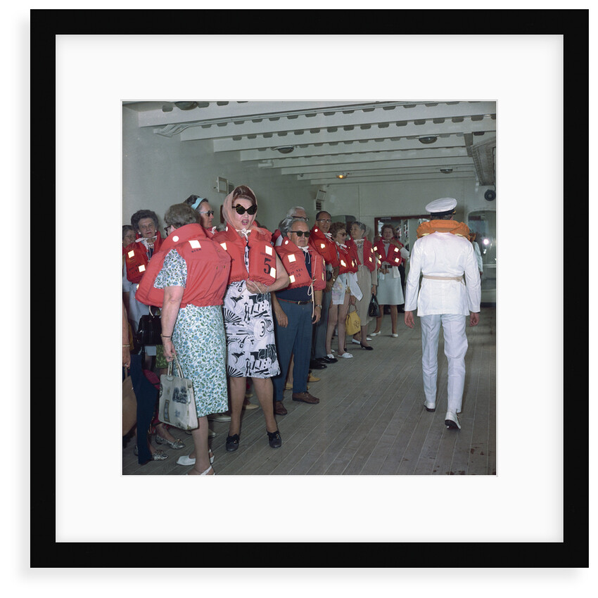 A group of passengers with lifejackets aboard 'Kungsholm' (1966), undergoing life boat drill by Marine Photo Service