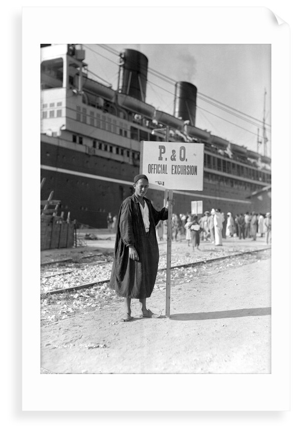 A Tunisian tour guide posing with his official P & O sign, Bizerte, Tunisia by Marine Photo Service