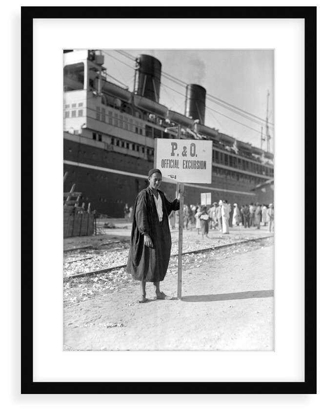 A Tunisian tour guide posing with his official P & O sign, Bizerte, Tunisia by Marine Photo Service