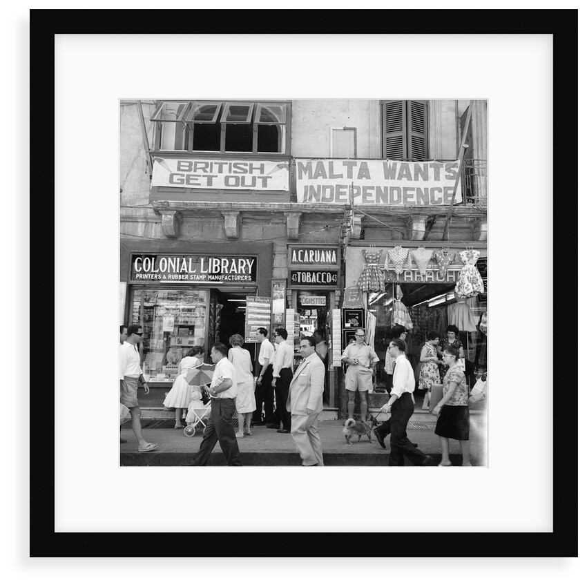 A view of shops with anti-British and pro-Independence signs, possibly on Kings Street, Valetta, Malta. by Marine Photo Service