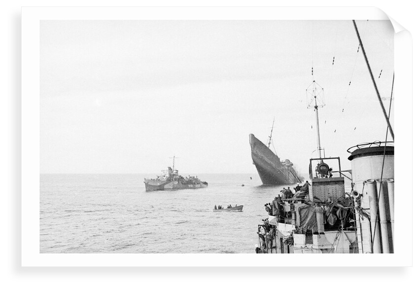 Photograph of Windsor Castle (1922) sinking in 1943,  distant port bow view with bow high in the air and escort destroyer 'Farndale' (1940) standing by 'Eskimo' in foreground by Lt JE Manners