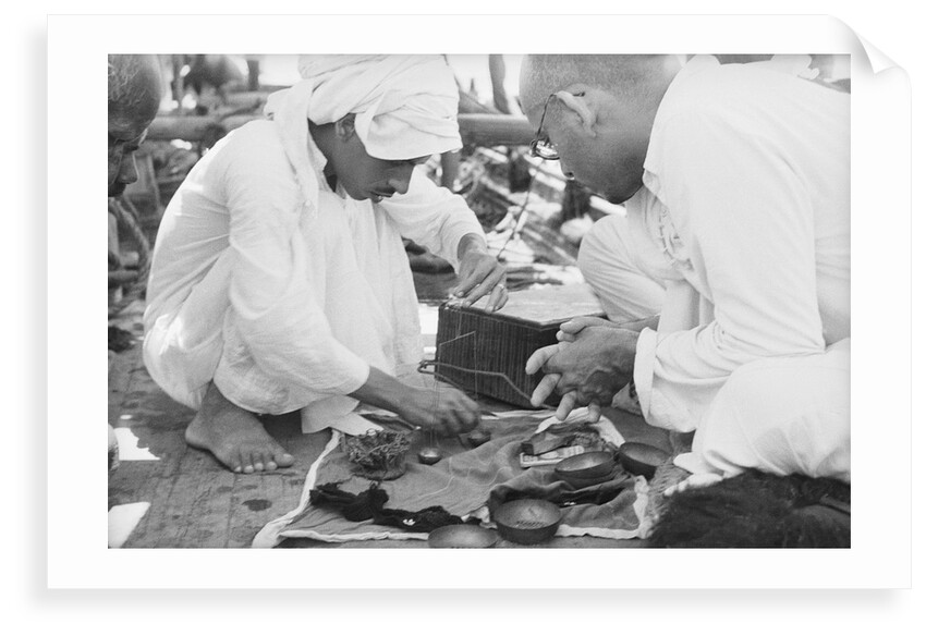 Pearl buyers examining pearls by Alan Villiers