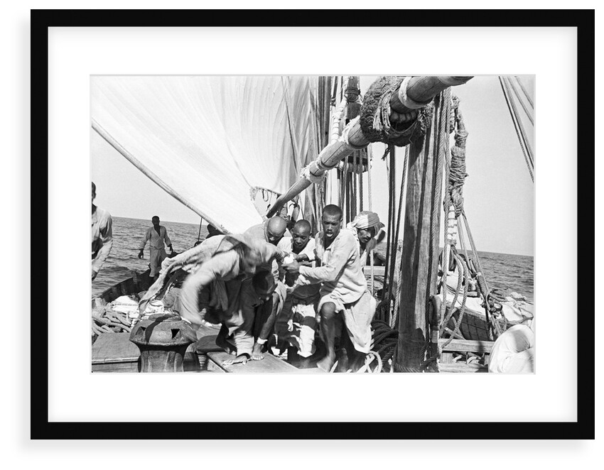 The crew labour on the mainsail after Haifun by Alan Villiers