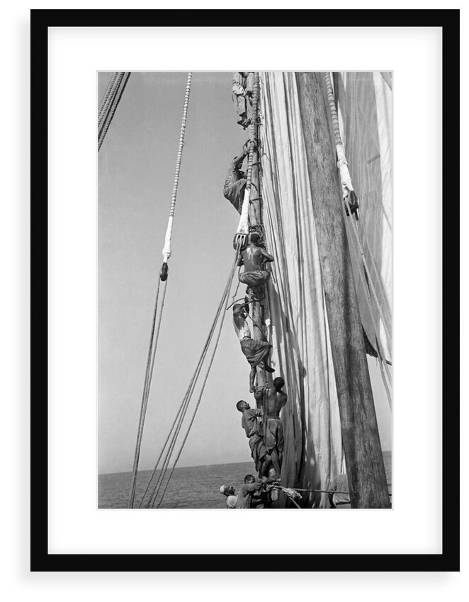 Kuwaiti sailors climbing aloft and working on the lateen yard by Alan Villiers