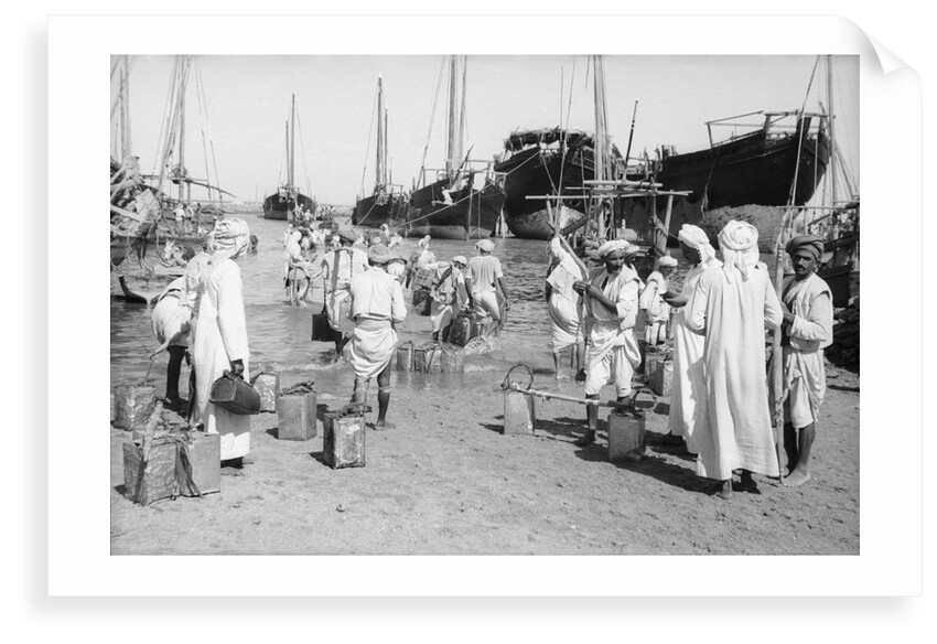 Water carriers filling their cans by Alan Villiers