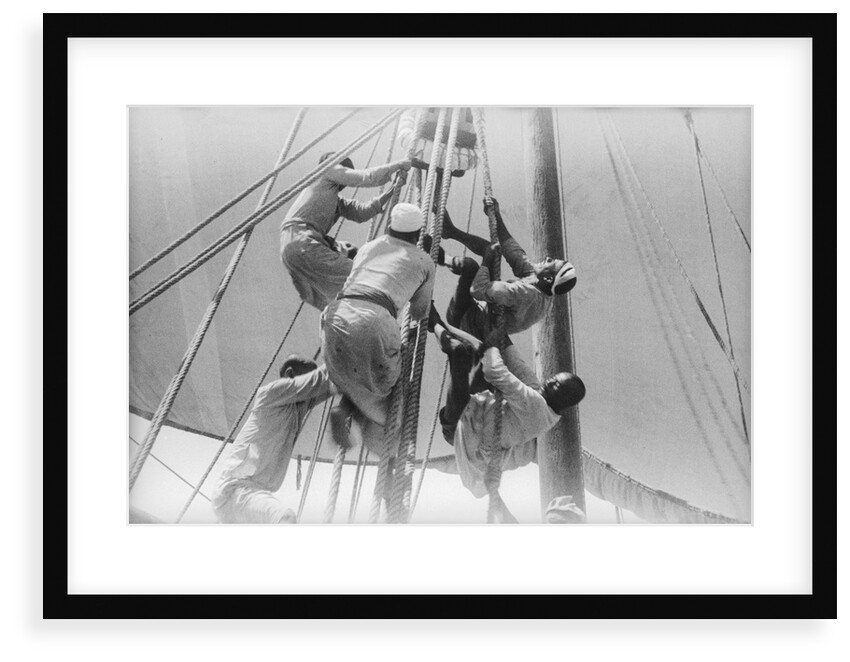 Sailors climbing the halyard blocks by Alan Villiers