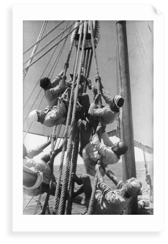 Sailors climbing the halyard blocks by Alan Villiers