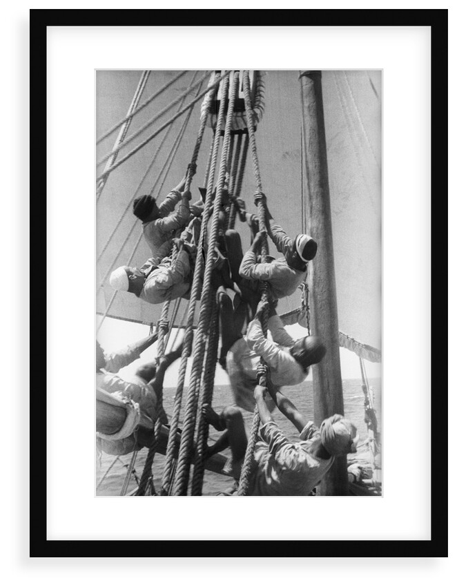 Sailors climbing the halyard blocks by Alan Villiers