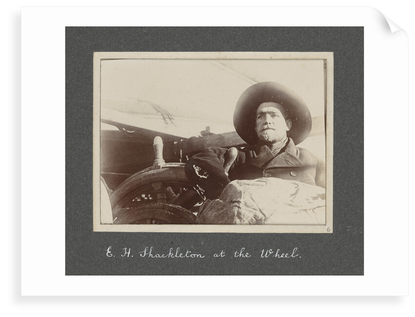 E. H. Shackleton at the wheel from National Antarctic Expedition photo album by Sir Ernest Henry Shackleton