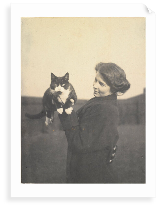 An informal photograph of Kathleen Alice Taylor holding Slabbie the black/white cat in her hands by Unknown