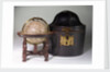 Sphere on stand, beside case by James Ferguson