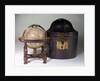 Sphere on stand, beside case by James Ferguson