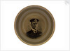 Plate glazed on a mustard ground with a gold rim by Ridgways
