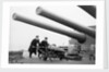 Two ratings pushing a 14-inch shell on a trolley on the battleship 'King George V' (1939). King George V carried about 800 shells for her 10 guns when loaded. by unknown