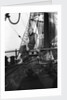 One of the crew on the forecastle head capstan by Alan Villiers