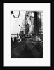 One of the crew on the forecastle head capstan by Alan Villiers