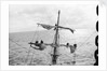 Aloft on the Mizzen furling the blown-out sails by Alan Villiers