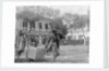 Two Chinese men carrying a load suspended from a pole between them by Kenneth Hurlstone Jones