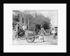 A Chinese man pushing a wooden wheelbarrow with a rickshaw in the background by Kenneth Hurlstone Jones