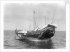 A baggala at anchor off Zanzibar discharging her cargo by Alan Villiers