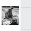 American soldier peeling onions while wearing a gas mask by Alan Villiers