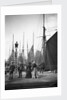 Men and women onlookers at the end of the quay looking at the forest of masts and sails in the harbour at Lowestoft, Suffolk by Smiths Suitall Ltd.
