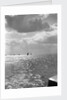 The sunlit North Sea from the harbour entrance with a number of trawlers under sail on the horizon at Lowestoft, Suffolk by Smiths Suitall Ltd.