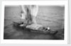 Indigenous boat at sea, laden with sacks by unknown